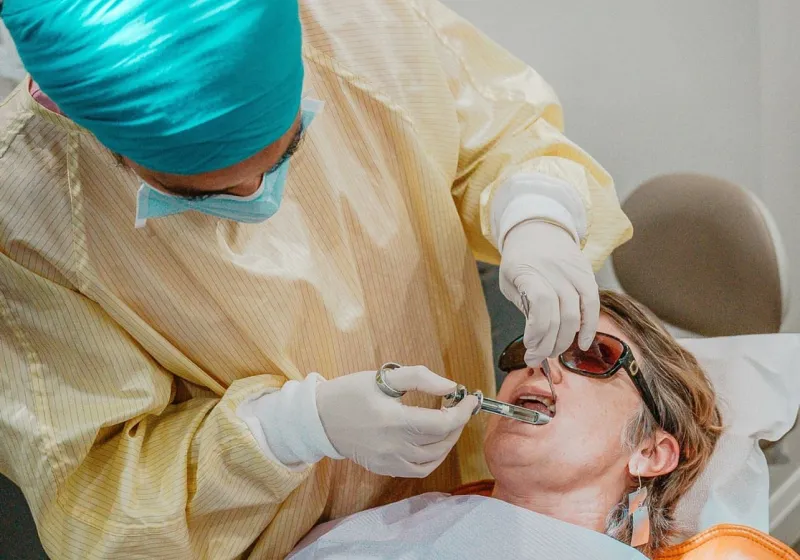 A dentist carefully numbing a patient before treatment